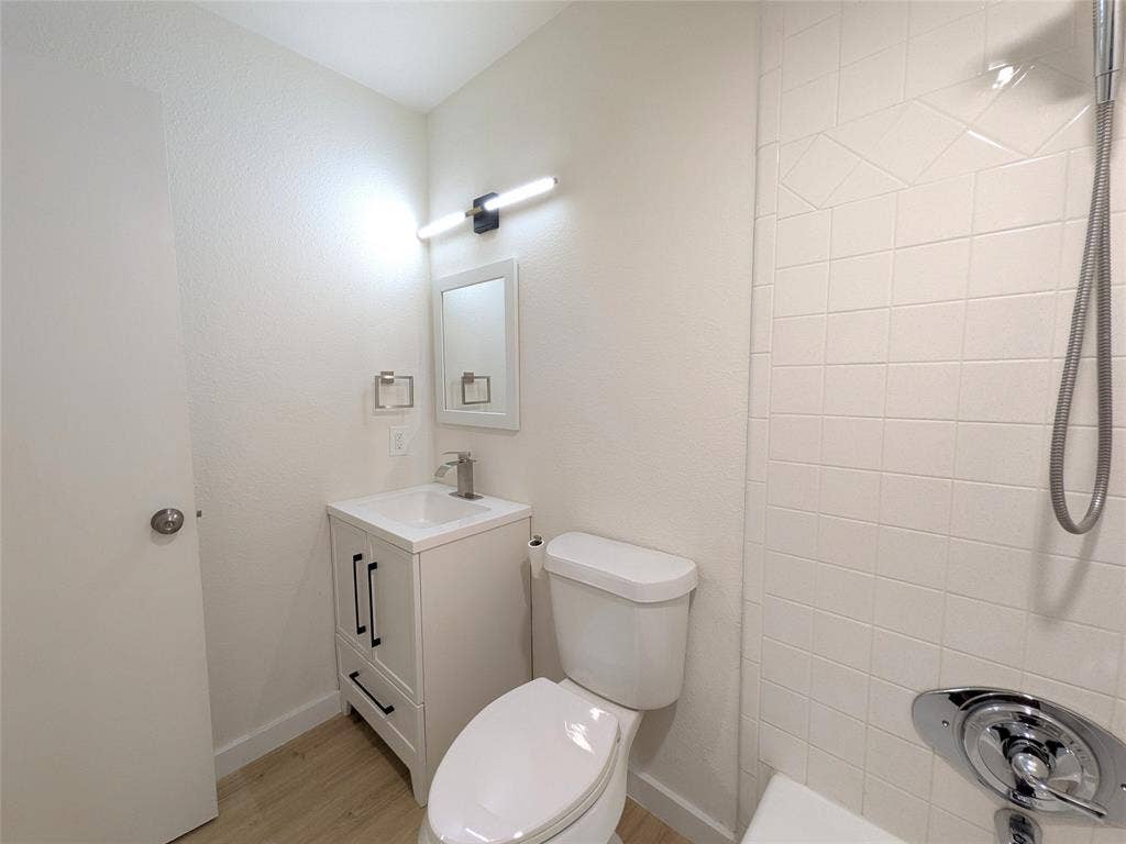 1400 Oakhill Drive, Plano, TX 75075 Contemporary bathroom featuring a white vanity with black hardware, a rectangular sink, and a chrome faucet