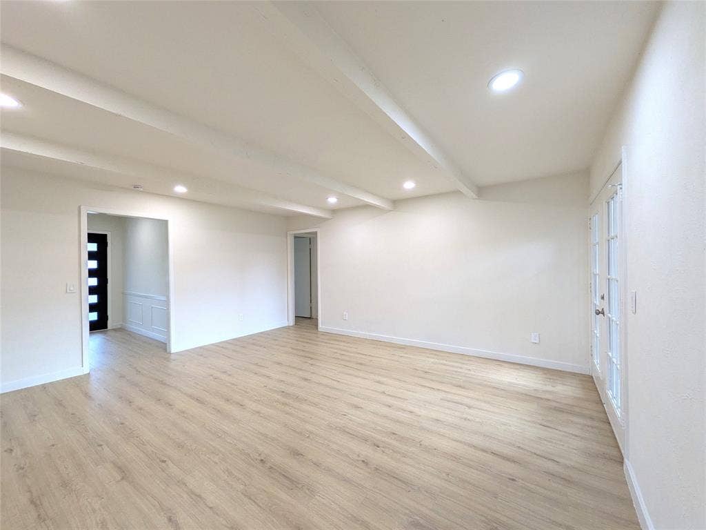 1400 Oakhill Drive, Plano, TX 75075 Spacious living area featuring light wood-finish flooring, recessed lighting, and exposed ceiling beams