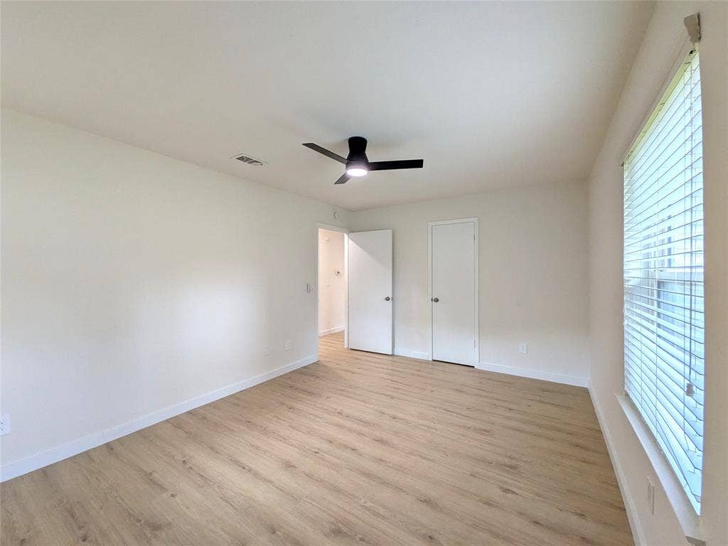 1400 Oakhill Drive, Plano, TX 75075 Spacious interior room featuring wood-finish flooring, a contemporary ceiling fan, and white baseboards
