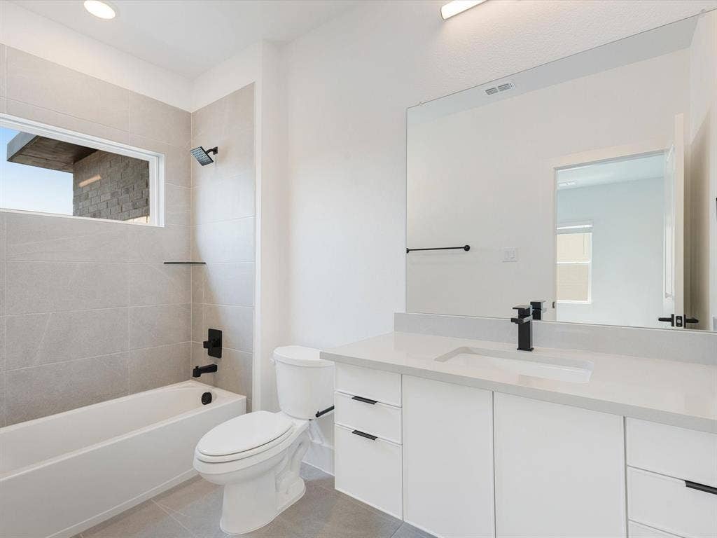 2317 Peters Colony Drive, Little Elm, TX 75036 Full bath with tub / shower combination, vanity, light tile patterned floors, and recessed lighting