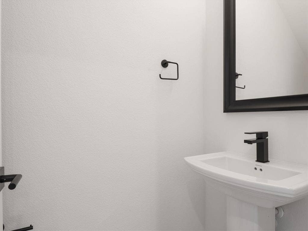 2317 Peters Colony Drive, Little Elm, TX 75036 Powder Bath with pedestal sink and framed mirror