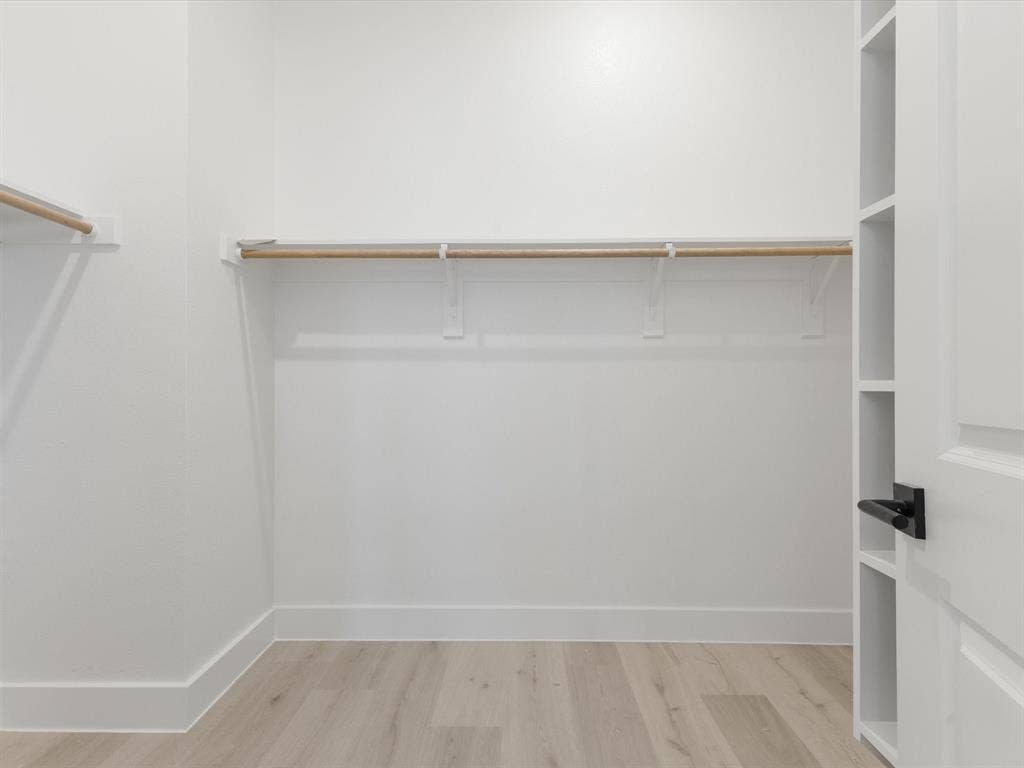 2317 Peters Colony Drive, Little Elm, TX 75036 Primary closet with light wood-type flooring