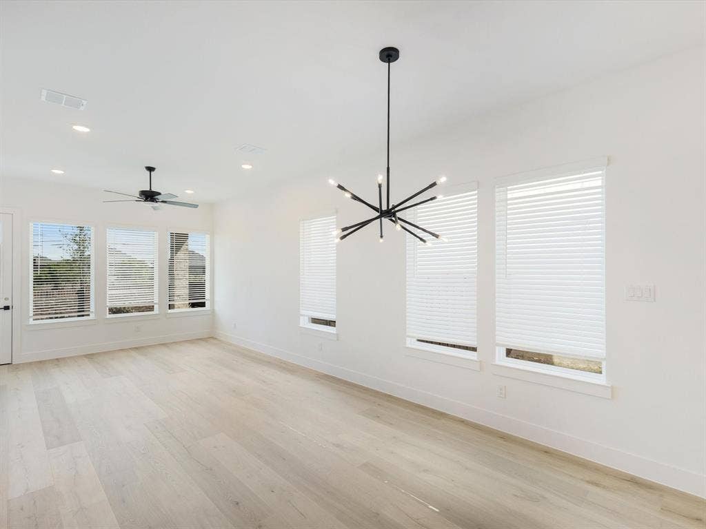 2317 Peters Colony Drive, Little Elm, TX 75036 Unfurnished dining area featuring light wood-style flooring, a chandelier, ceiling fan, and recessed lighting