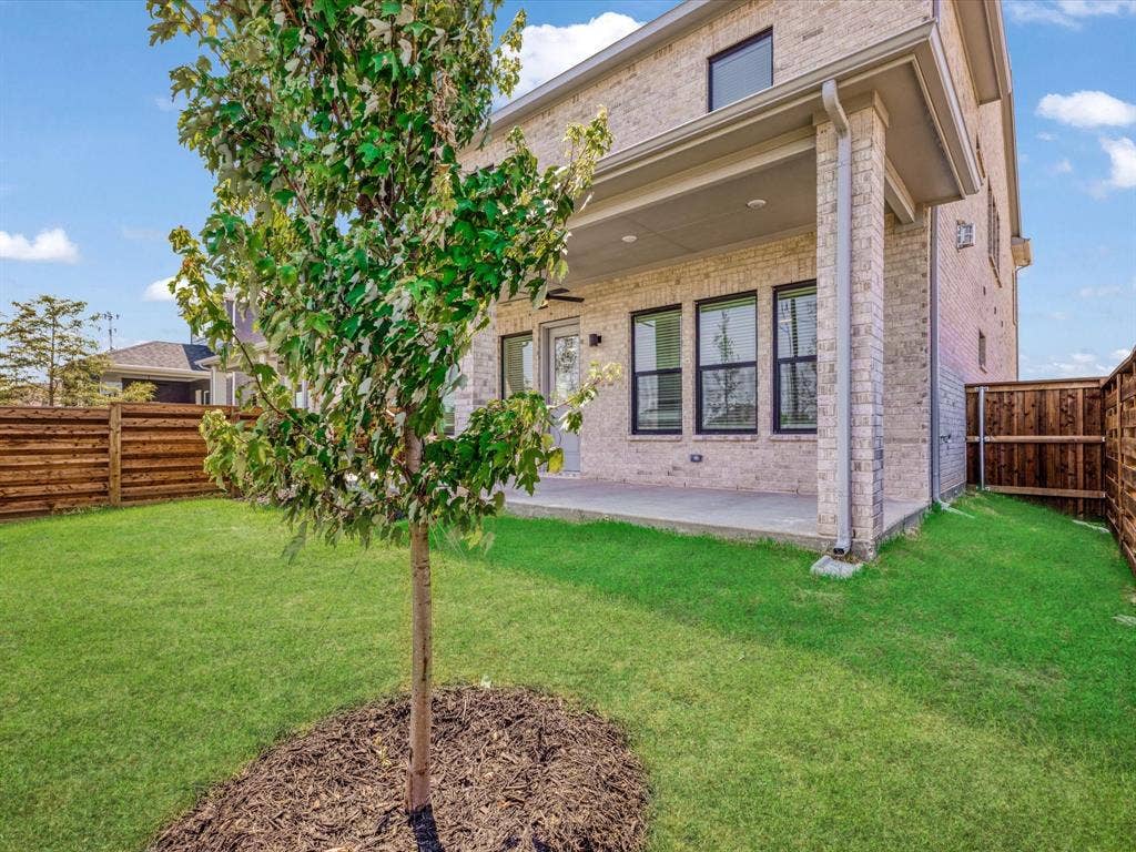 2317 Peters Colony Drive, Little Elm, TX 75036 Rear view of house featuring a fenced backyard, brick siding, a patio area, and ceiling fan