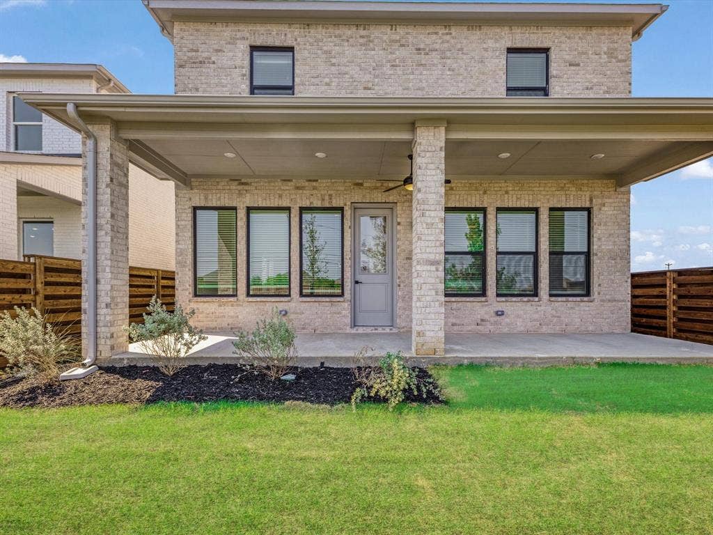2317 Peters Colony Drive, Little Elm, TX 75036 Rear view of house featuring brick siding, ceiling fan, and a patio area