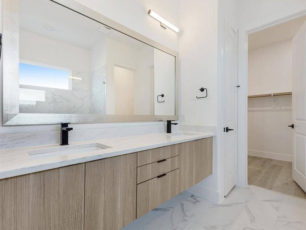 2317 Peters Colony Drive, Little Elm, TX 75036 Primary Bathroom with light marble finish flooring, a spacious closet, and a marble finish shower