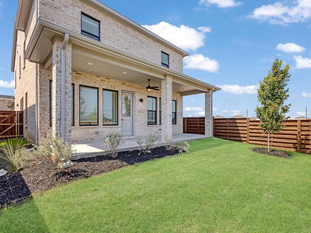 2317 Peters Colony Drive, Little Elm, TX 75036 Rear view of house with brick siding, a fenced backyard, a ceiling fan, and a patio area