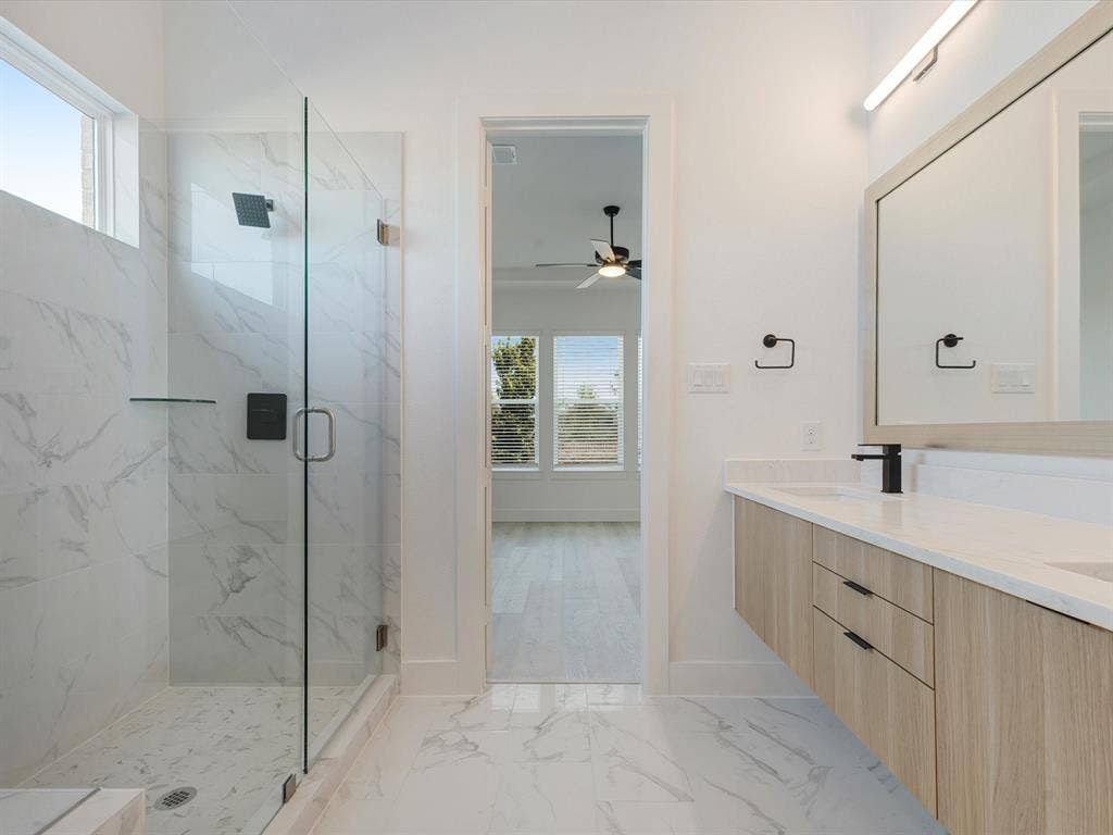 2317 Peters Colony Drive, Little Elm, TX 75036 Primary Bathroom with healthy amount of natural light, a marble finish shower, light marble finish flooring
