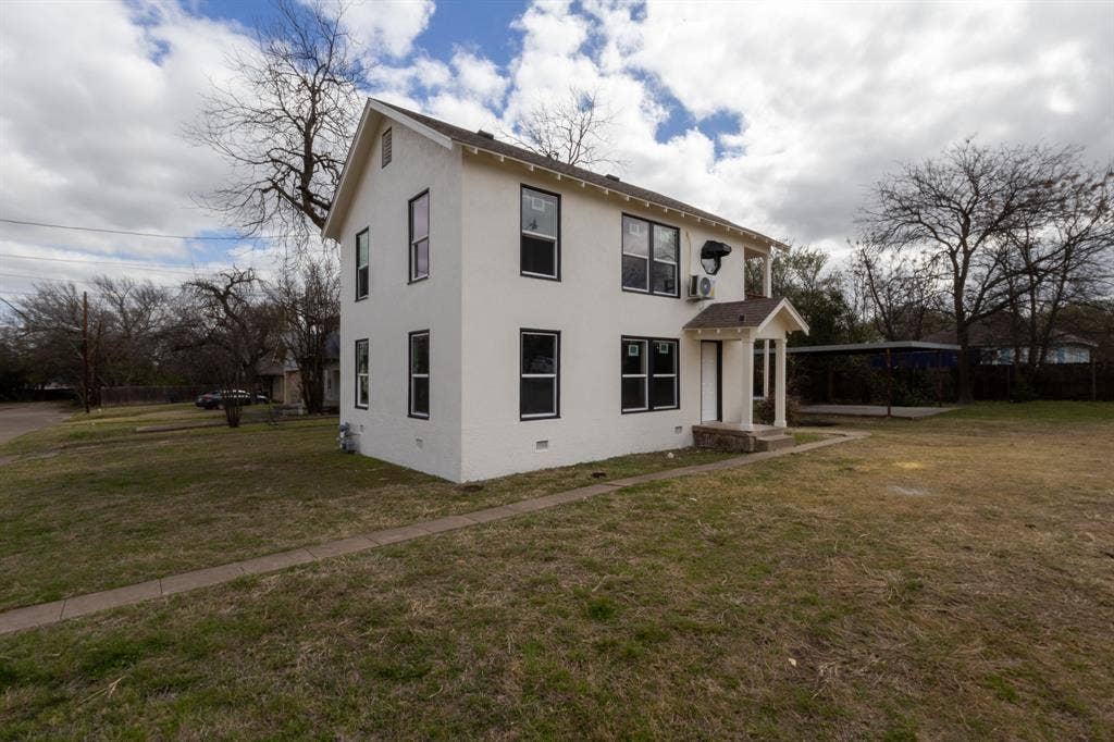 1704 Ethel Avenue, #B, Waco, TX 76707 Two-story exterior with white stucco finish and black-framed windows
