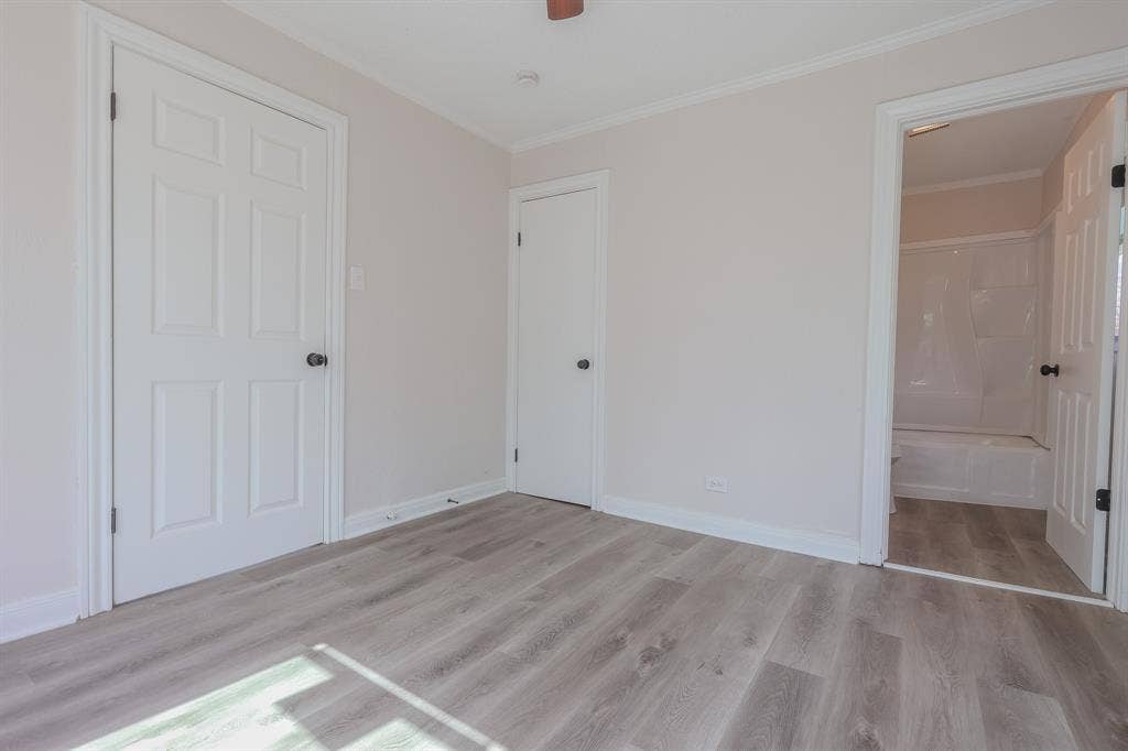 1704 Ethel Avenue, #B, Waco, TX 76707 Light gray wall paint, wood-finish flooring, white paneled doors, and white trim