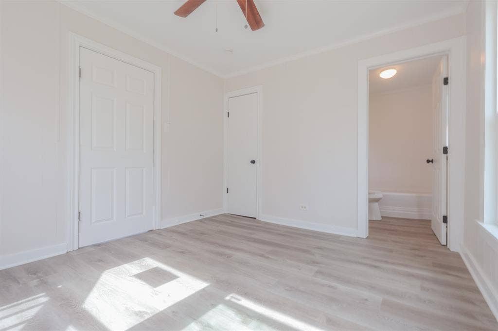 1704 Ethel Avenue, #B, Waco, TX 76707 Wood-finish flooring throughout, white paneled doors, and a ceiling fan