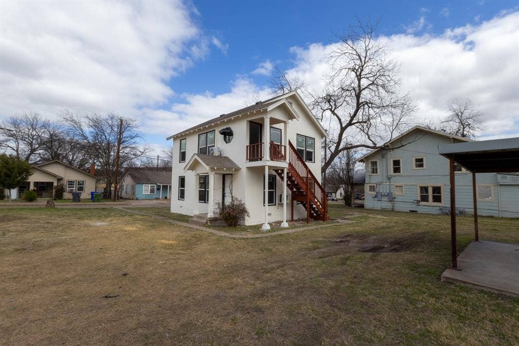 1704 Ethel Avenue, #B, Waco, TX 76707 Two-story stucco exterior with a covered entry, upper-level balcony, and exterior staircase