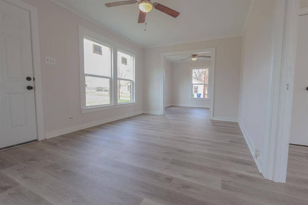 1704 Ethel Avenue, #B, Waco, TX 76707 Wood-finish flooring throughout, multiple windows, overhead ceiling fan, and white trim