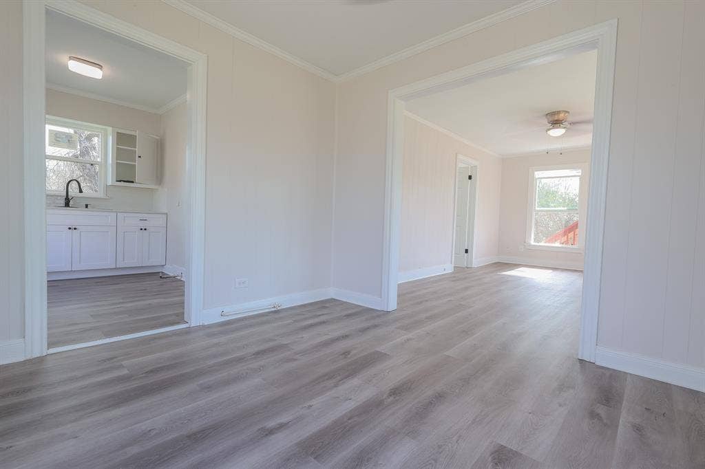 1704 Ethel Avenue, #B, Waco, TX 76707 Wood-finish flooring throughout, bright white trim, and light-toned walls
