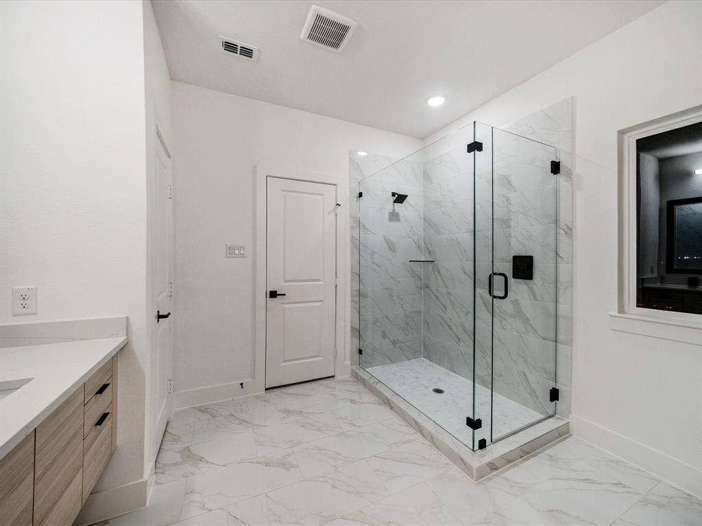 2313 Peters Colony Drive, Little Elm, TX 75036 Full bathroom with a marble finish shower, vanity, and light marble finish flooring