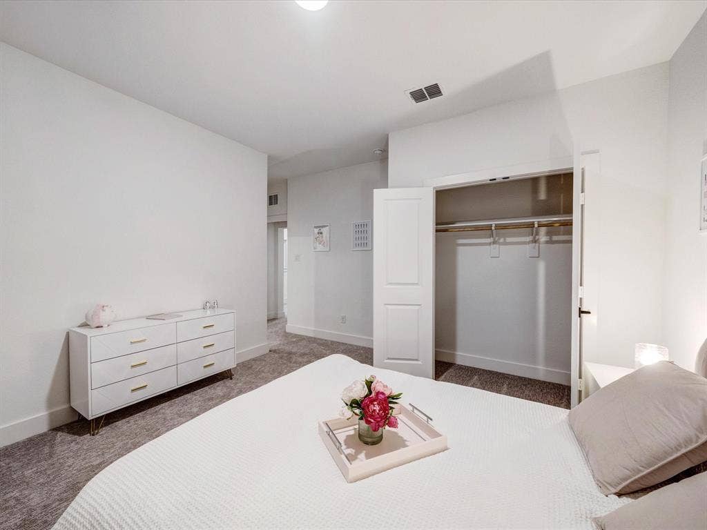 2313 Peters Colony Drive, Little Elm, TX 75036 Bedroom with dark colored carpet and a closet
