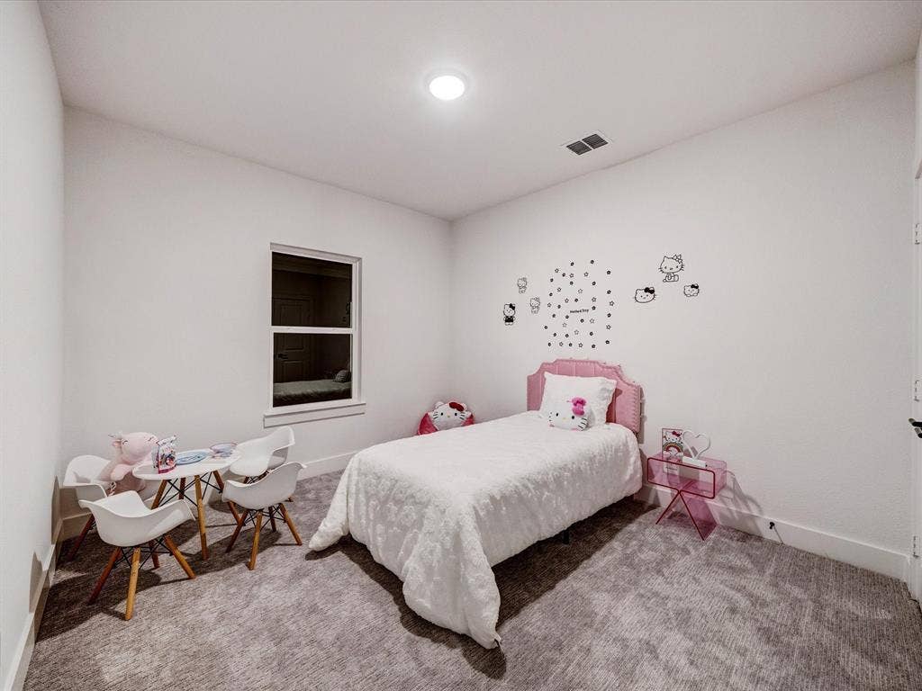 2313 Peters Colony Drive, Little Elm, TX 75036 Carpeted bedroom featuring baseboards