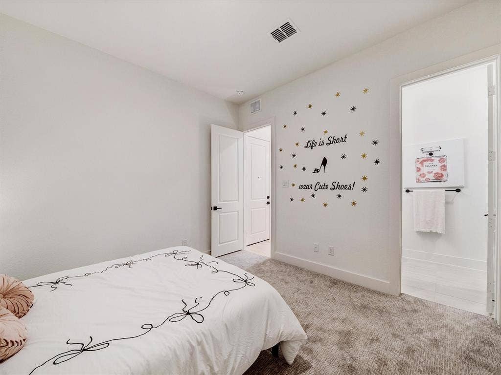 2313 Peters Colony Drive, Little Elm, TX 75036 Bedroom featuring light carpet and connected bathroom