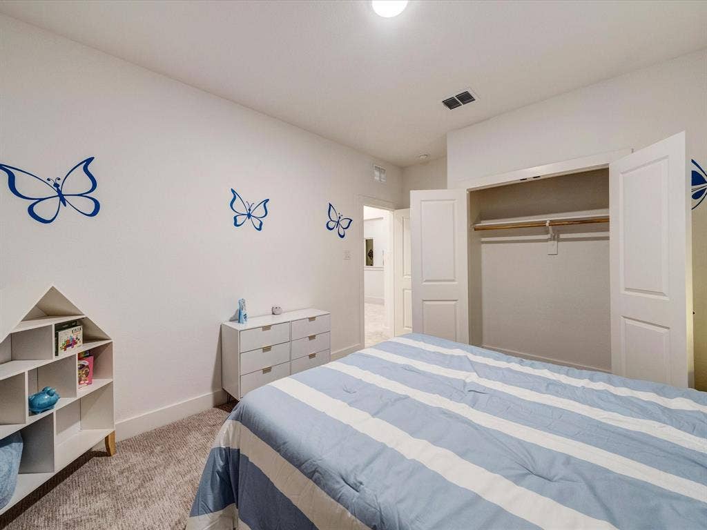 2313 Peters Colony Drive, Little Elm, TX 75036 Bedroom with light colored carpet and a closet