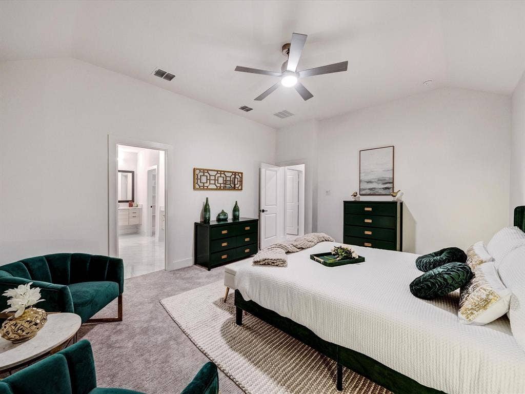 2313 Peters Colony Drive, Little Elm, TX 75036 Carpeted bedroom with vaulted ceiling, ceiling fan, and ensuite bathroom