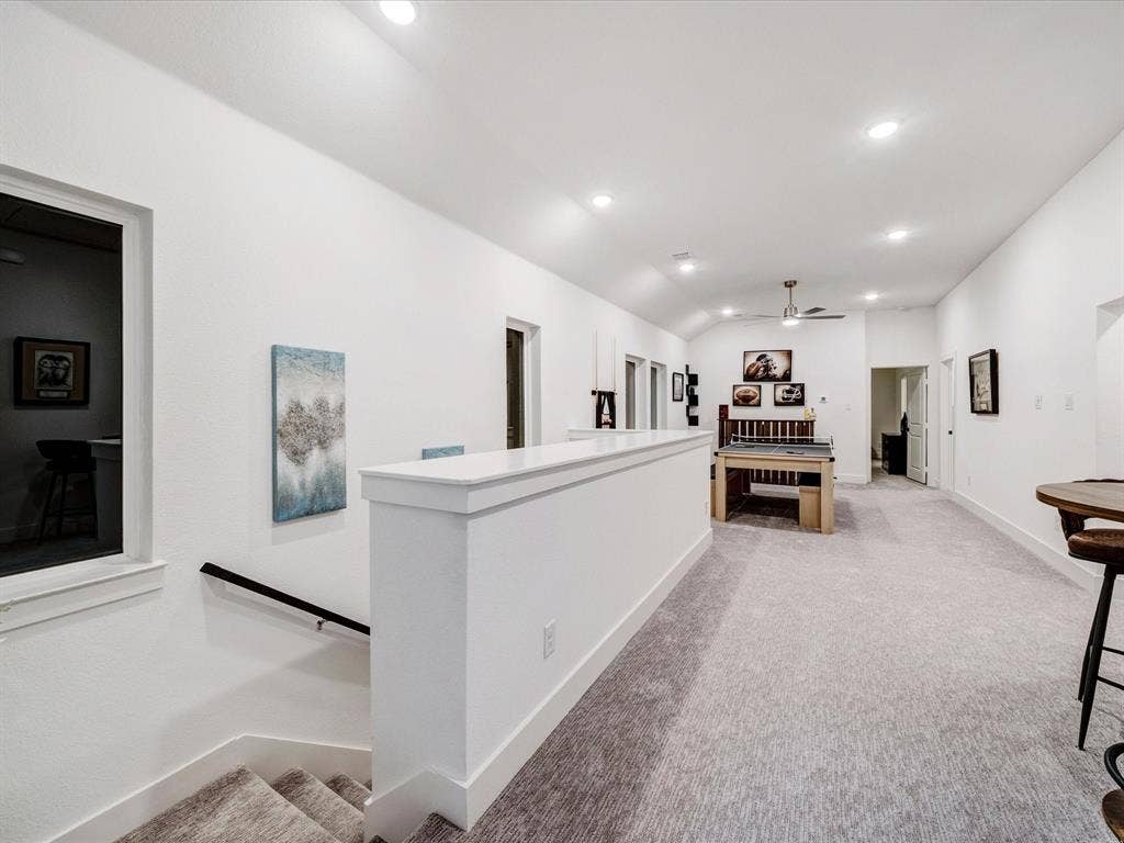 2313 Peters Colony Drive, Little Elm, TX 75036 Hall with recessed lighting, light carpet, lofted ceiling, and an upstairs landing
