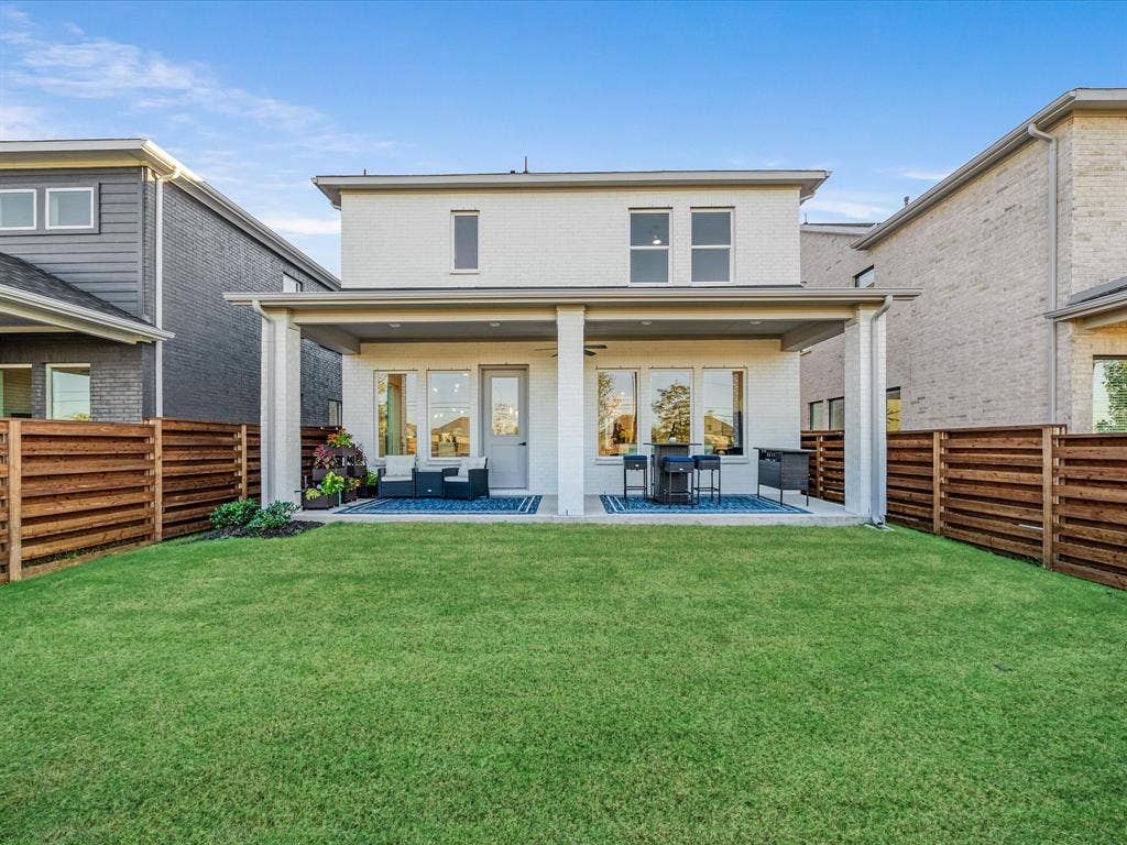 2313 Peters Colony Drive, Little Elm, TX 75036 Back of property featuring a patio, brick siding, and a fenced backyard