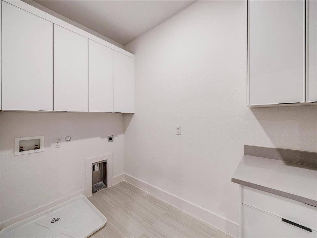 2313 Peters Colony Drive, Little Elm, TX 75036 Laundry area featuring gas dryer hookup, cabinet space, electric dryer hookup, and hookup for a washing machine