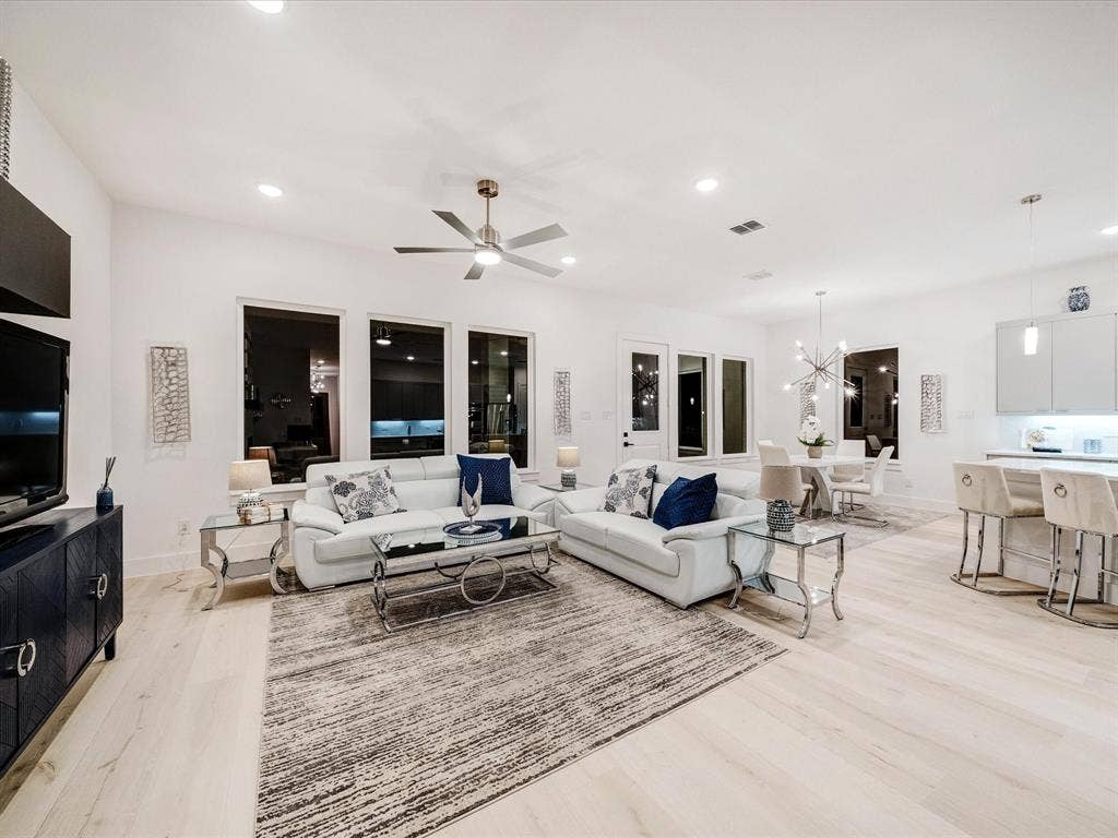 2313 Peters Colony Drive, Little Elm, TX 75036 Living area featuring recessed lighting, ceiling fan, light wood finished floors, and a chandelier