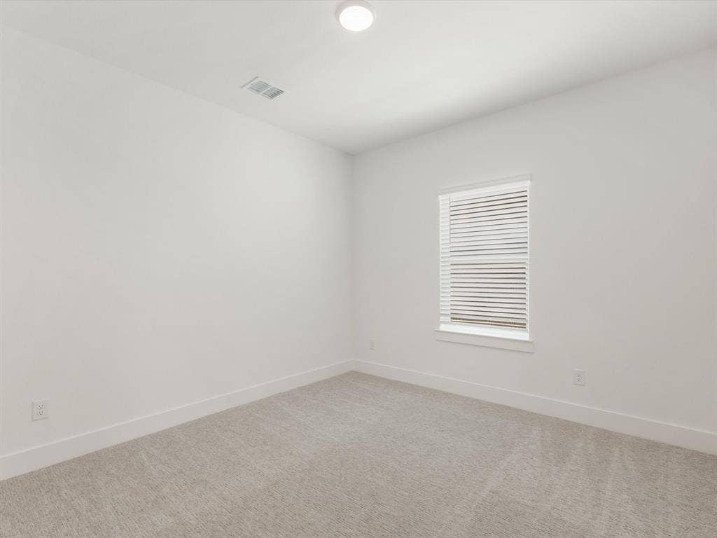 Bedroom 5 featuring baseboards and light colored carpet