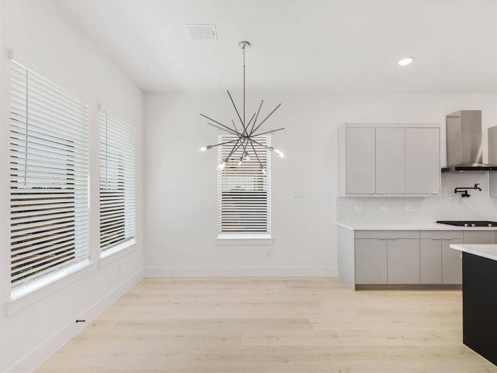 Dining area featuring recessed lighting, light wood-style flooring, plenty of natural light, and a chandelier