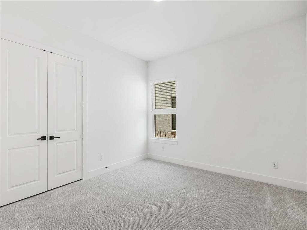 Downstairs Mother in law suite with ensuite featuring carpet floors and a closet