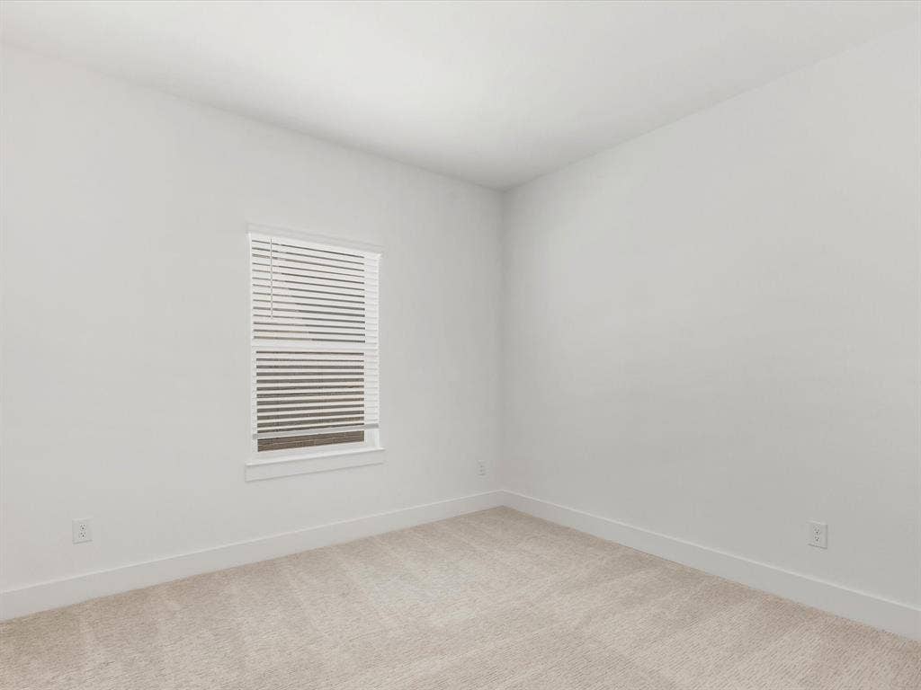 Bedroom 4 featuring baseboards and light carpet