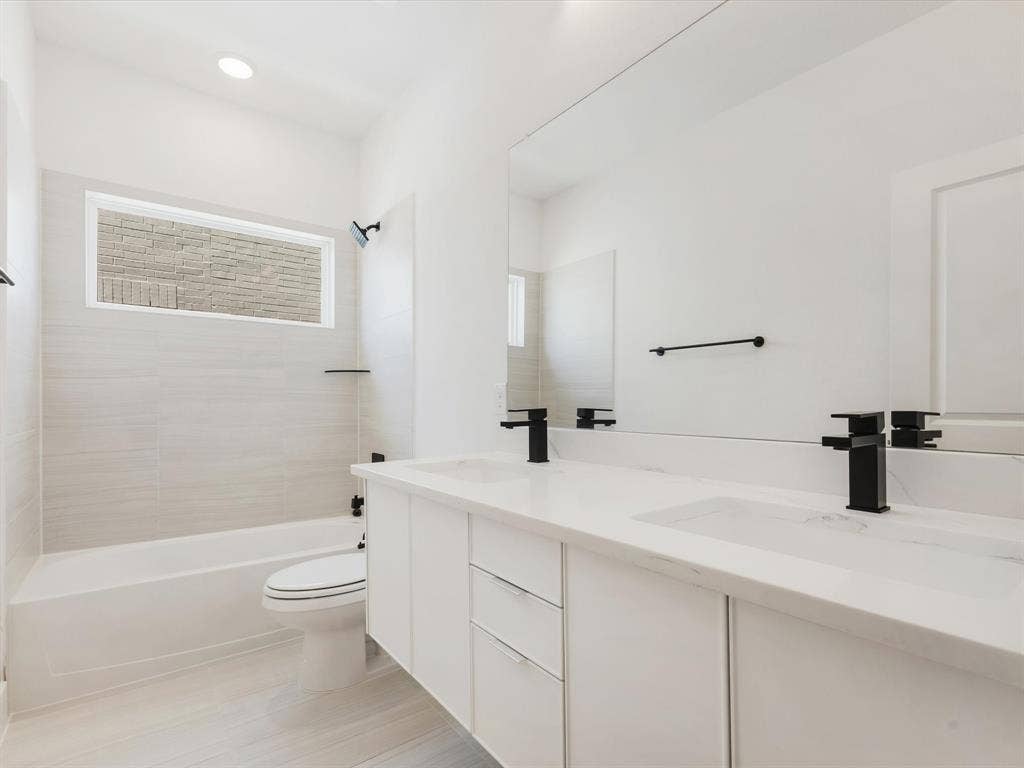 Bathroom 4 featuring dual sinks and floating cabinets