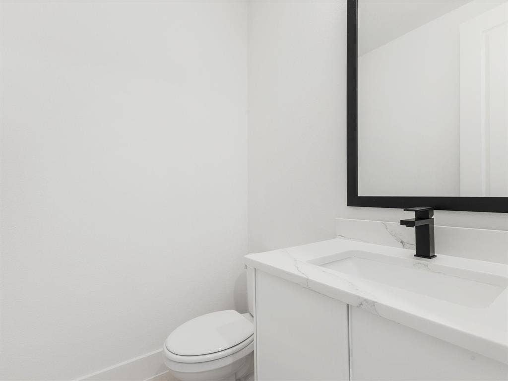 Half bath featuring vanity and toilet