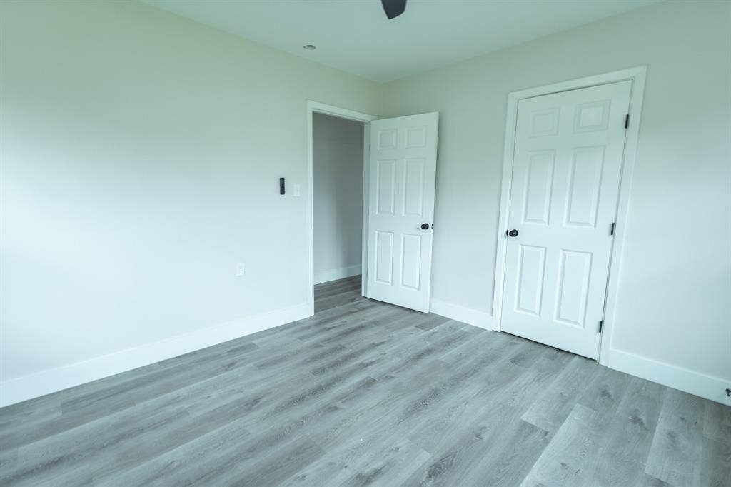 1716 Ethel Avenue, #1714, 1718, 1720, Waco, TX 76707 Pale gray walls with white trim, wood-finish flooring, and white paneled doors