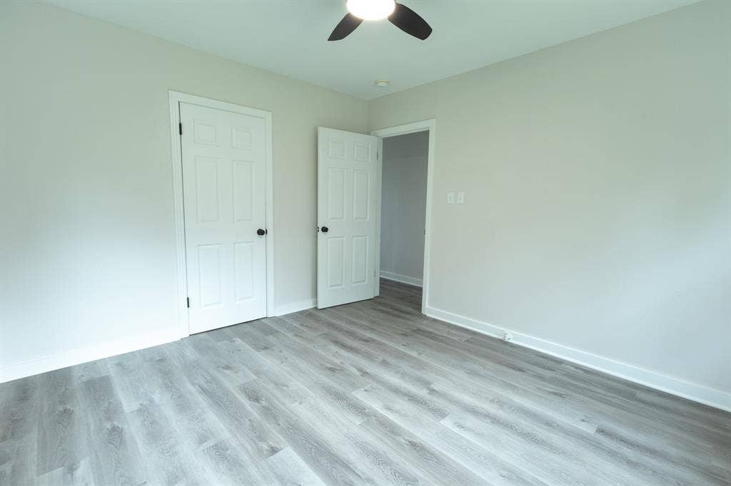 1716 Ethel Avenue, #1714, 1718, 1720, Waco, TX 76707 Wood-finish flooring throughout, light-toned walls, white trim, white interior doors, and a ceiling fan