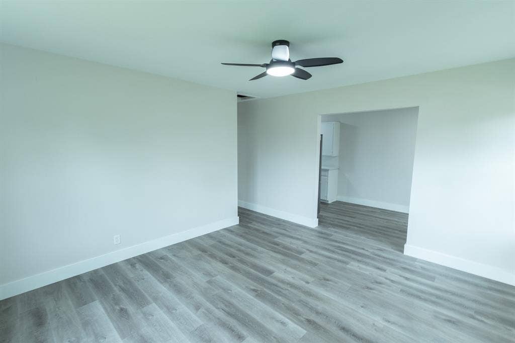 1716 Ethel Avenue, #1714, 1718, 1720, Waco, TX 76707 Wood-finish flooring throughout, bright white walls, and a contemporary ceiling fan with integrated lighting