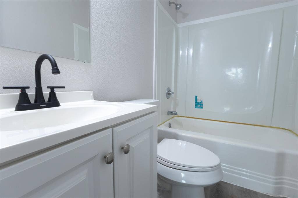 1716 Ethel Avenue, #1714, 1718, 1720, Waco, TX 76707 White vanity with shaker-style cabinetry, matte black faucet, and integrated sink