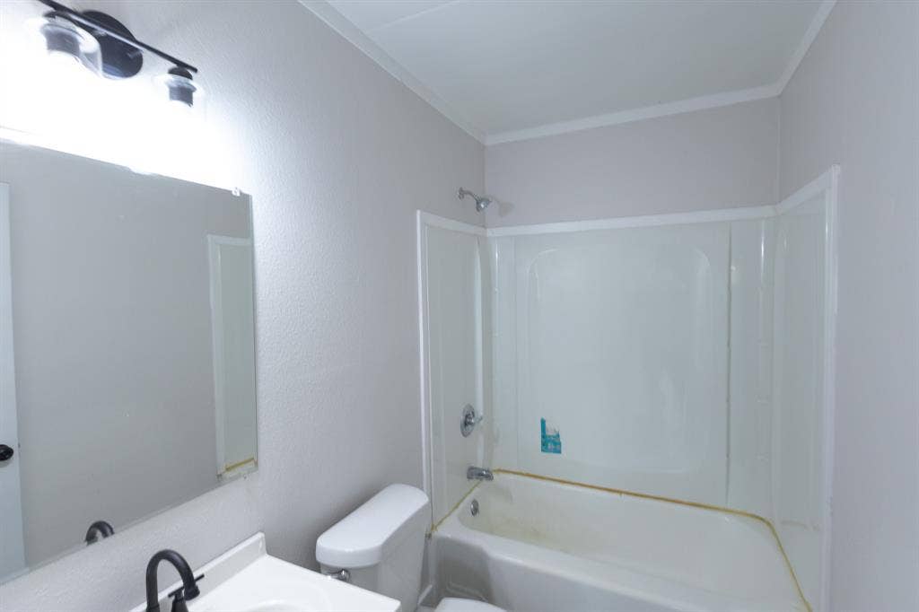 1716 Ethel Avenue, #1714, 1718, 1720, Waco, TX 76707 Built-in tub with integrated shower, vanity with an integrated sink, and a wall-mounted mirror