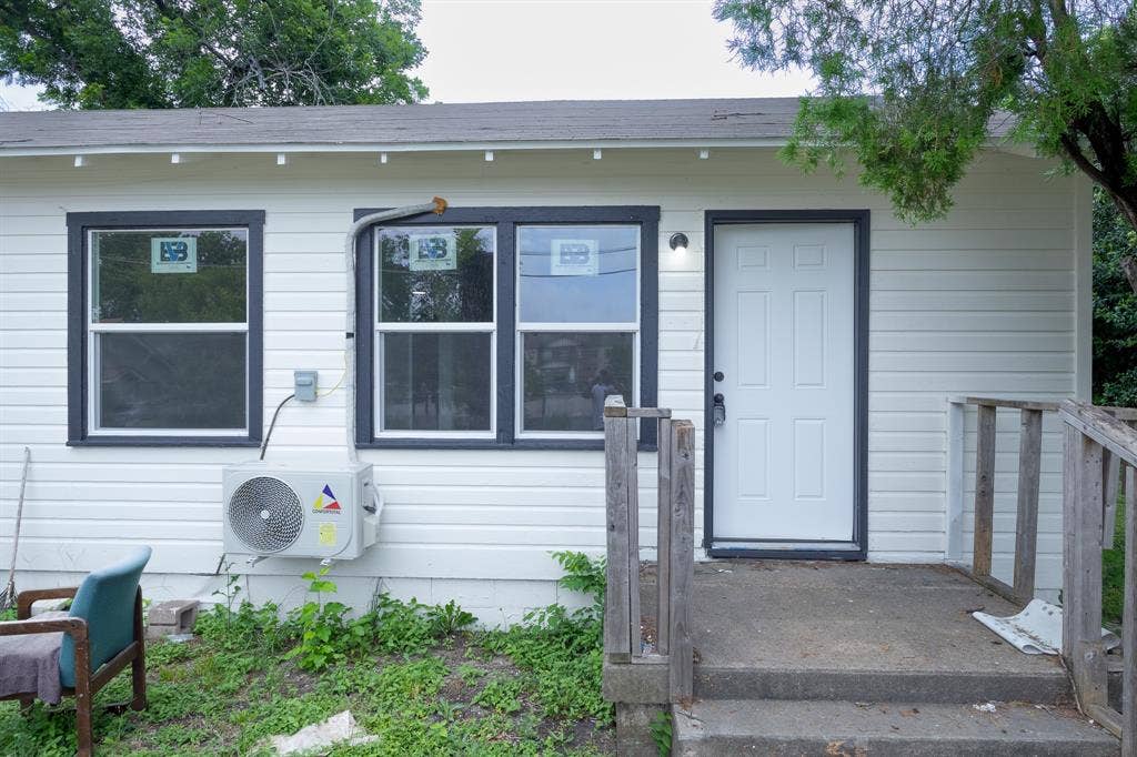 1716 Ethel Avenue, #1714, 1718, 1720, Waco, TX 76707 White paneled siding exterior with dark trim windows and a white paneled door
