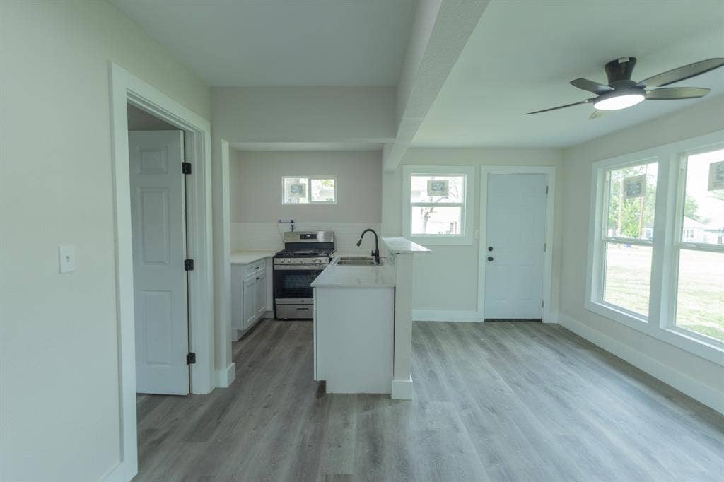 1716 Ethel Avenue, #1714, 1718, 1720, Waco, TX 76707 Open-concept living space featuring wood-finish flooring, a ceiling fan, and multiple large windows