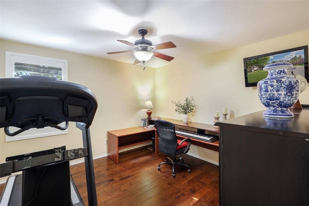 5409 Running Brook Lane, McKinney, TX 75071 Wood-finish flooring, ceiling fan with integrated lighting, built-in desk, and a wall-mounted television