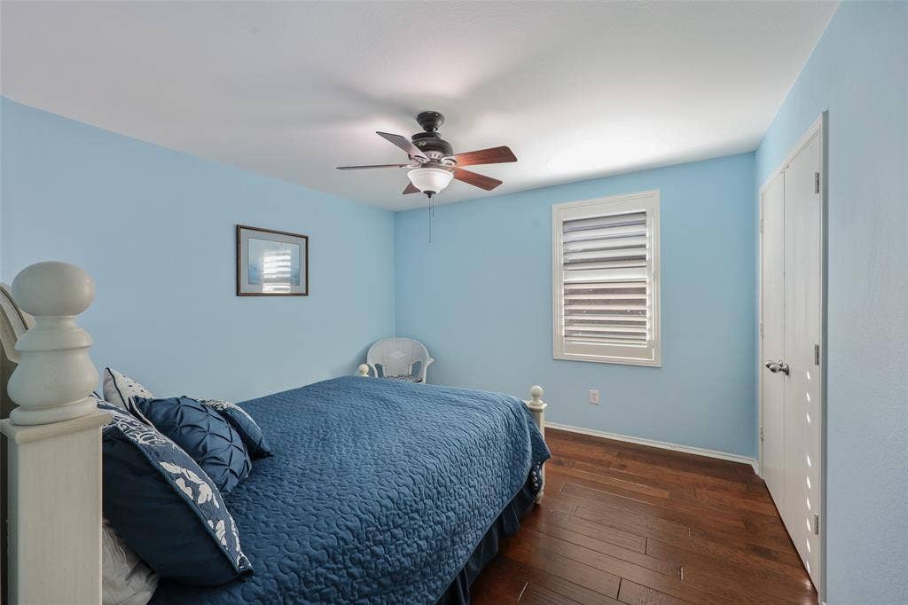 5409 Running Brook Lane, McKinney, TX 75071 Wood-finish flooring, ceiling fan with integrated lighting, window with plantation shutters, and bi-fold closet doors