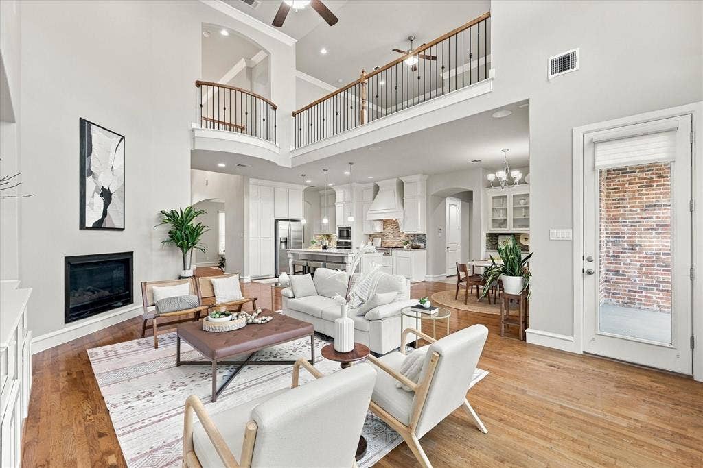 6200 Corsica Way, Plano, TX 75024 Living Room has a fireplace focal point and opens to the kitchen areas