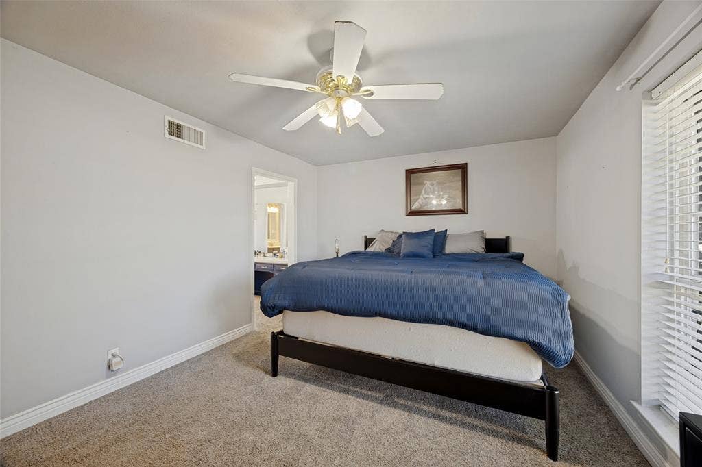 6401 Stonewall Street, Greenville, TX 75402 Carpeted room with a ceiling fan, window with blinds, and white walls