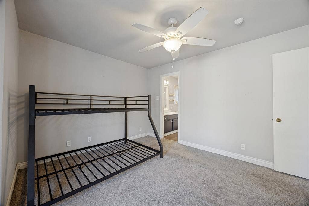 6401 Stonewall Street, Greenville, TX 75402 Wall-to-wall carpeting and a ceiling fan with integrated lighting