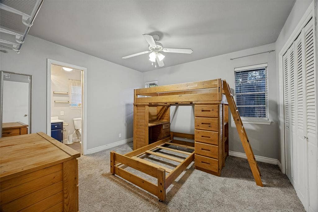 6401 Stonewall Street, Greenville, TX 75402 Carpeted flooring, ceiling fan, window with blinds, and louvered bi-fold closet doors