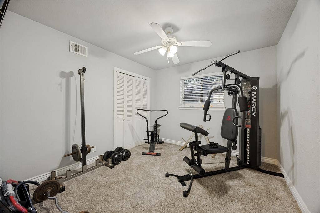 6401 Stonewall Street, Greenville, TX 75402 Carpeted room featuring a ceiling fan, a window with blinds, and bi-fold closet doors