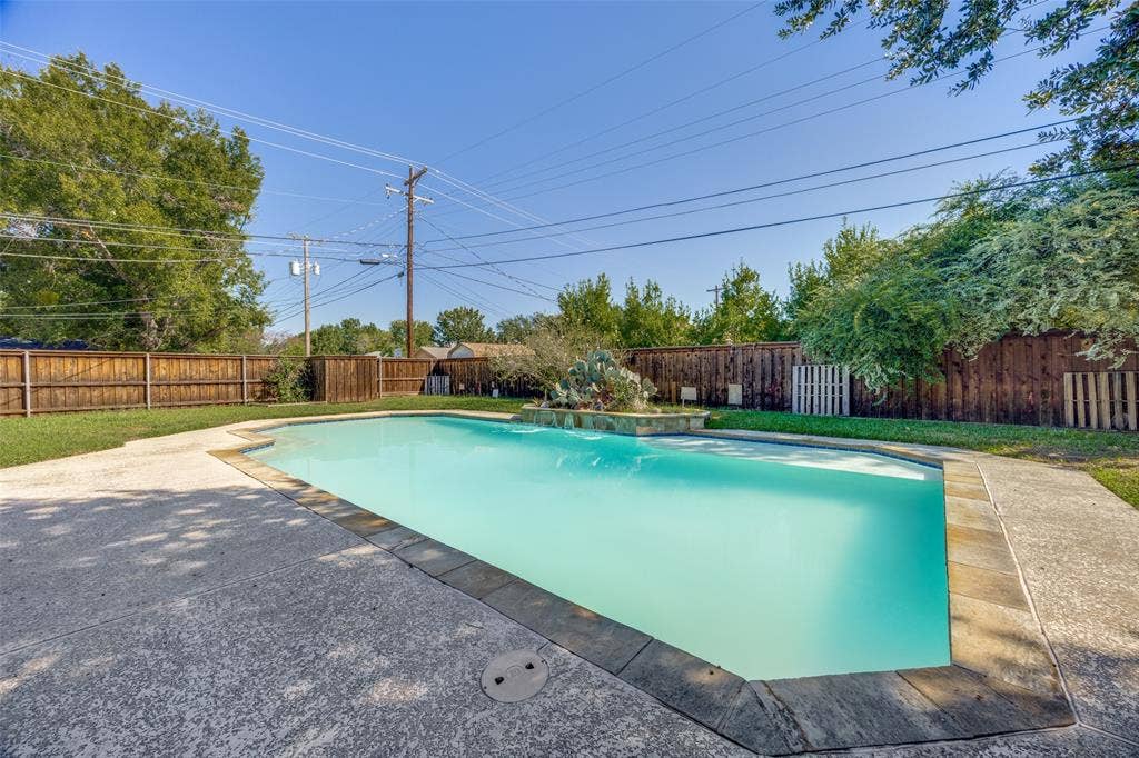 6401 Stonewall Street, Greenville, TX 75402 In-ground swimming pool with flagstone coping