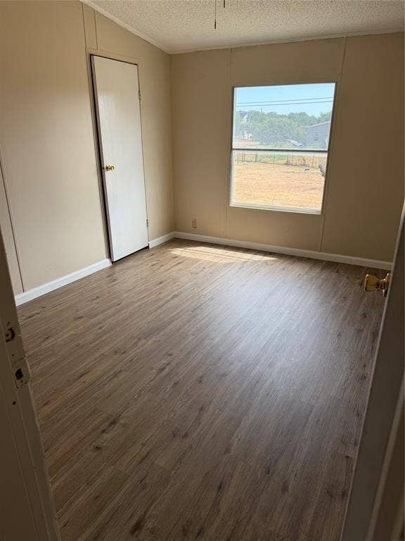 143 Summit Ridge Lane, Springtown, TX 76082 Wood-finish flooring throughout, neutral tone walls, and a single window